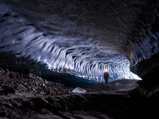 Person hiking in an ice cave